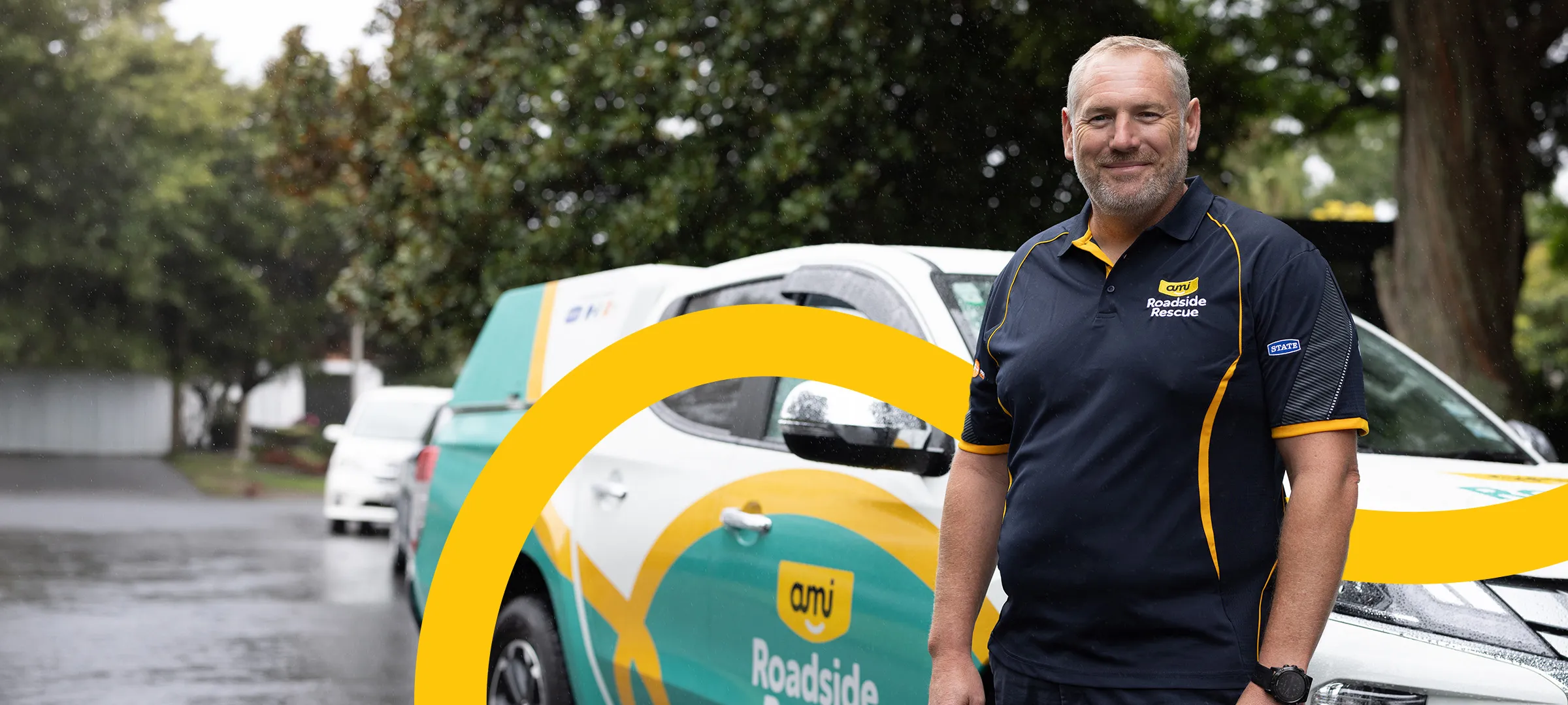 Gordon Brown, CEO of AMI Roadside Rescue, by a branded van