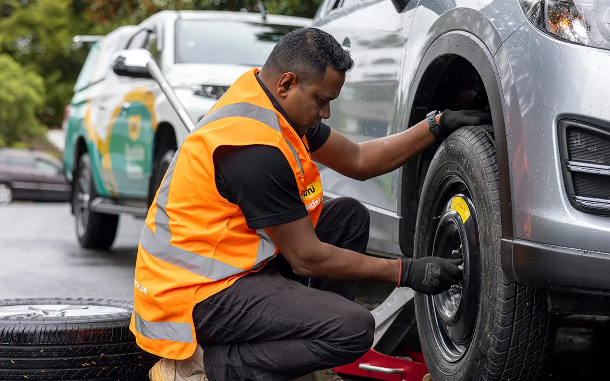 AMI Roadside Rescue technician fitting and balancing a new tyre at a customer's home.
